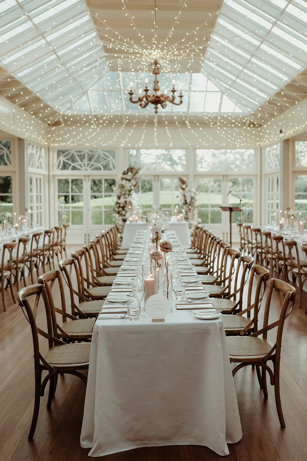 Wedding reception with long tables and fairy lights