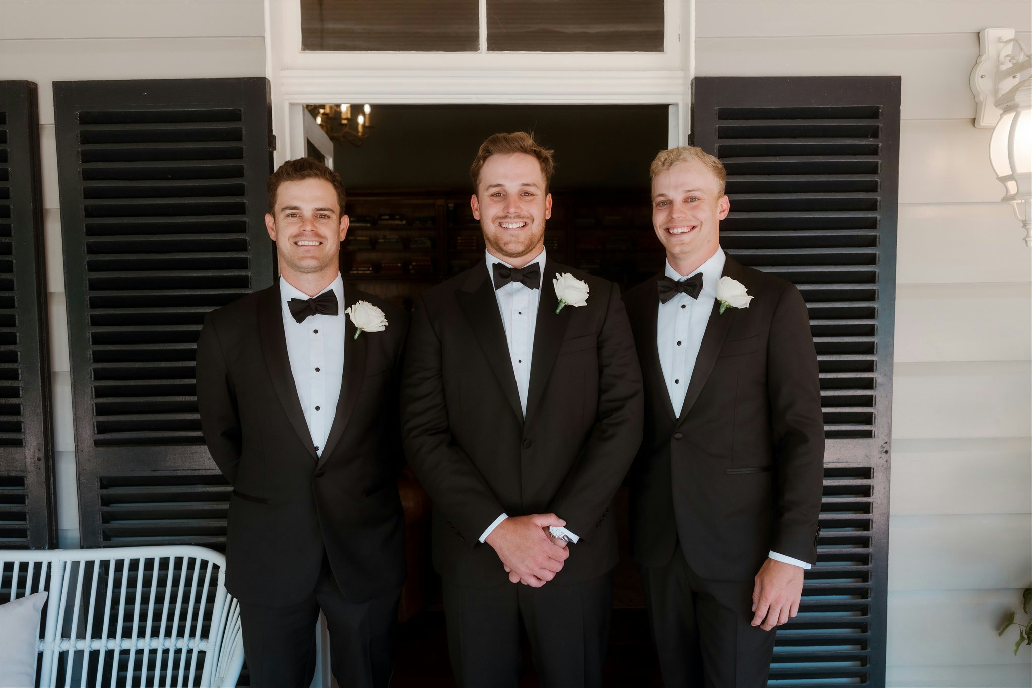 Groom and groomsmen standing together smiling