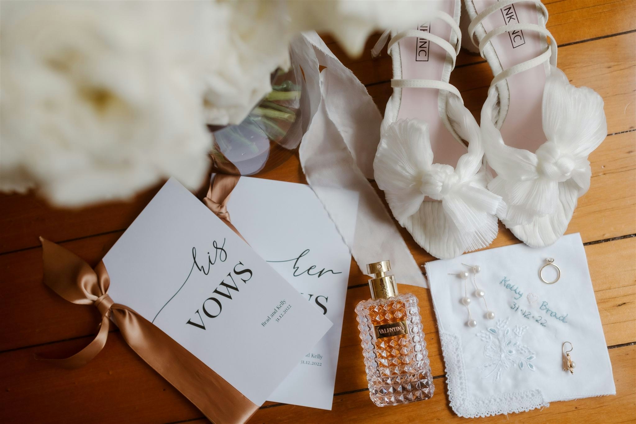 Wedding shoes, perfume, invitations and earrings