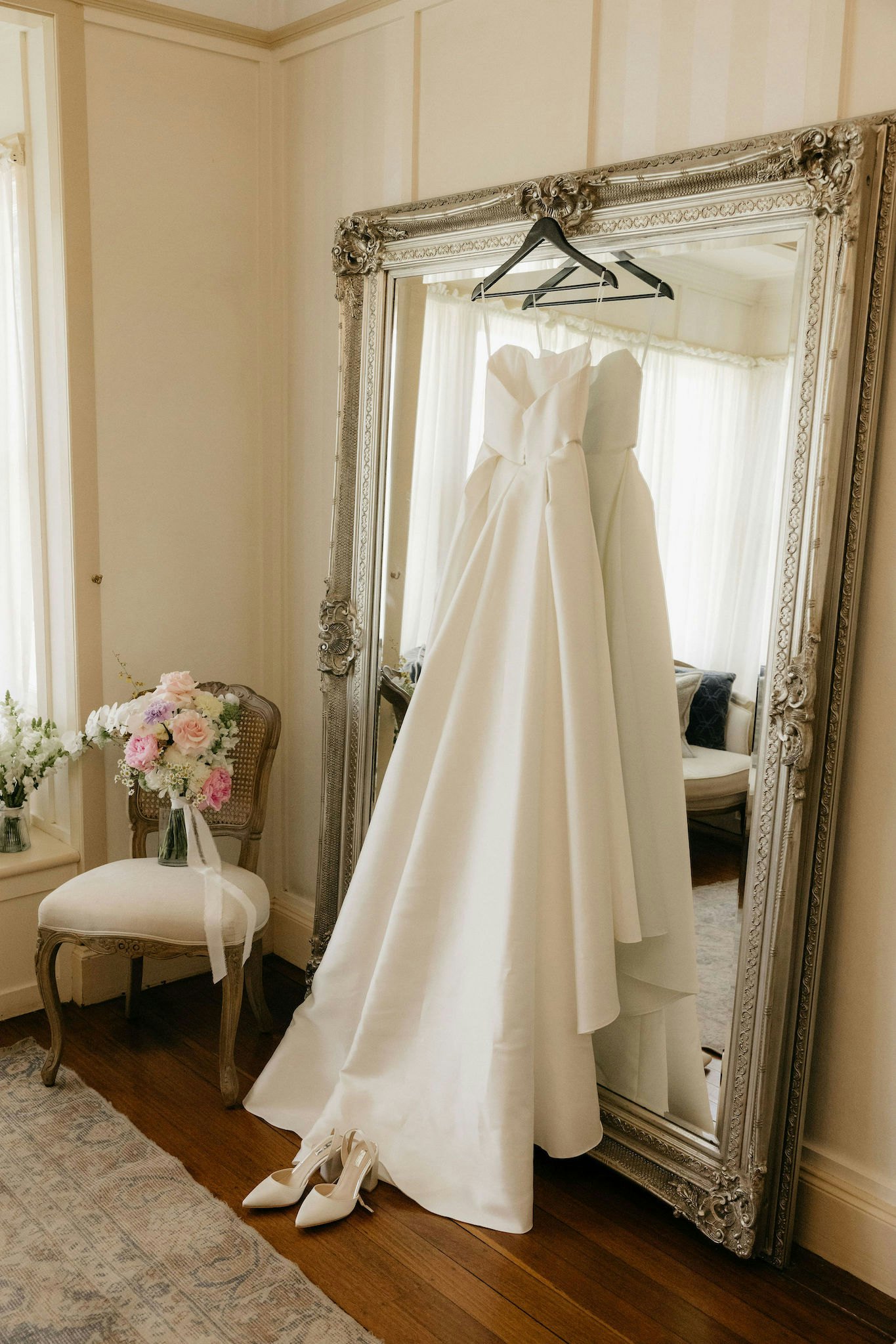 Wedding dress hanging from mirror