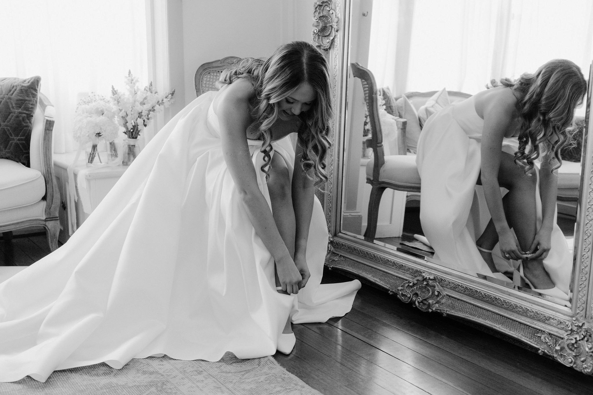 Bride putting on wedding shoes