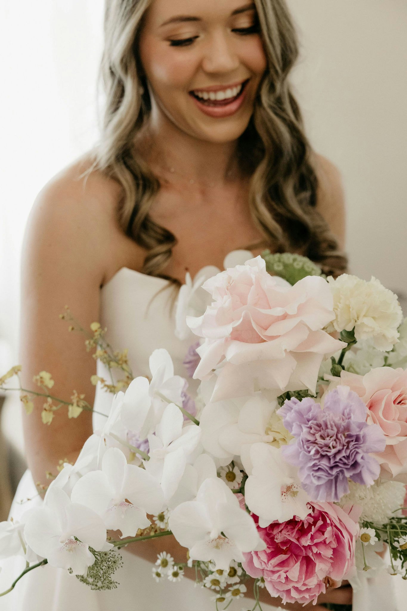Bride holding colourful bouquet
