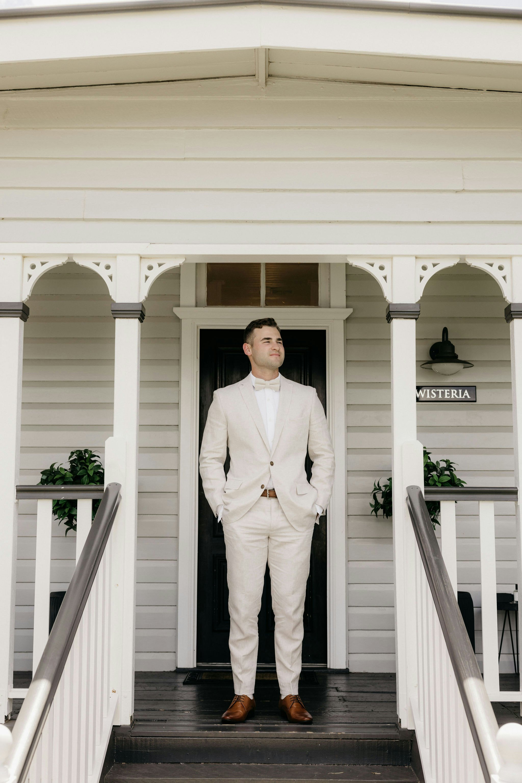 Man standing on steps at front of house