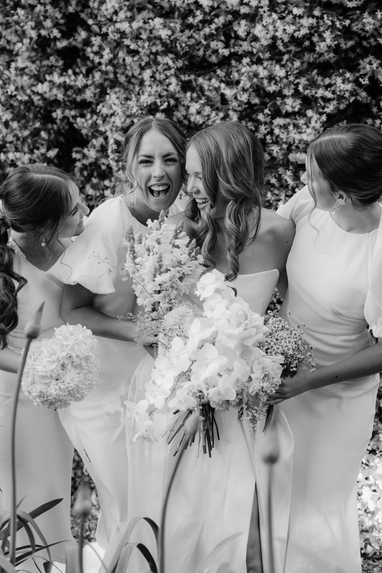 Bride and bridesmaids laughing together