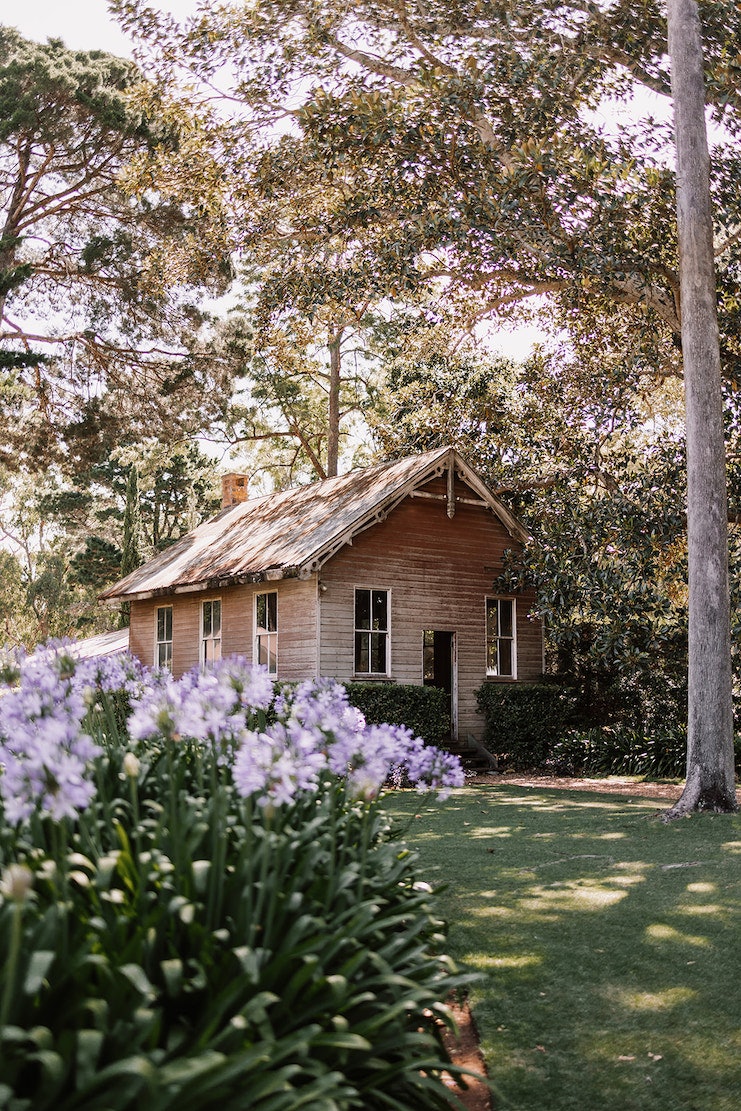 Old School House with purple flowers