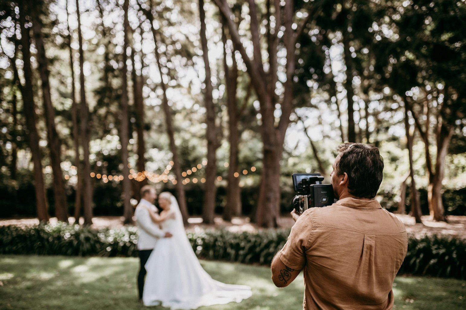 Photographer taking photo of wedding couple
