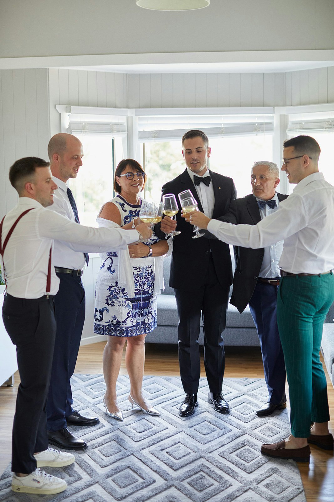 Groom and family toasting wine