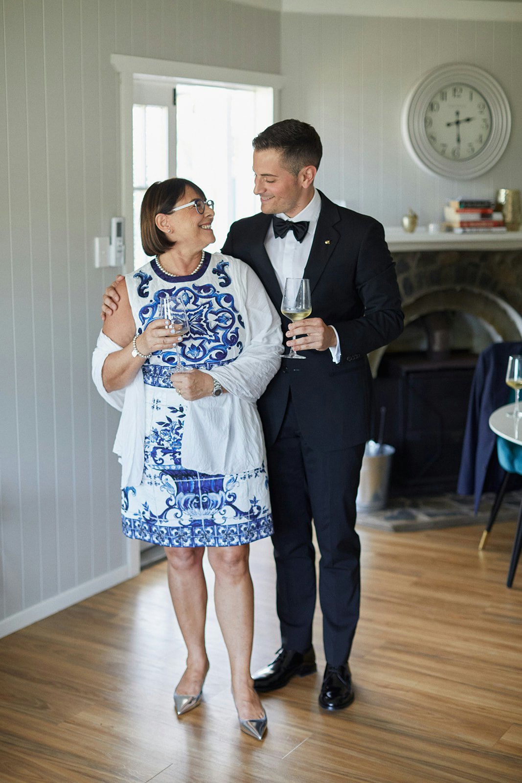 Groom and mother of bride holding wine
