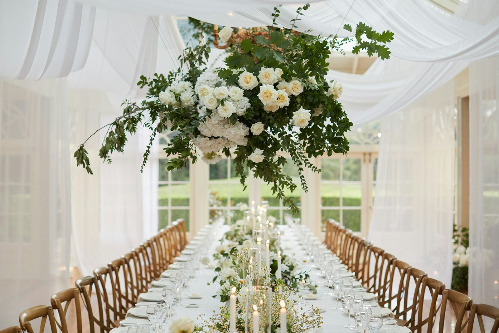Wedding reception with flowers and white draping linen