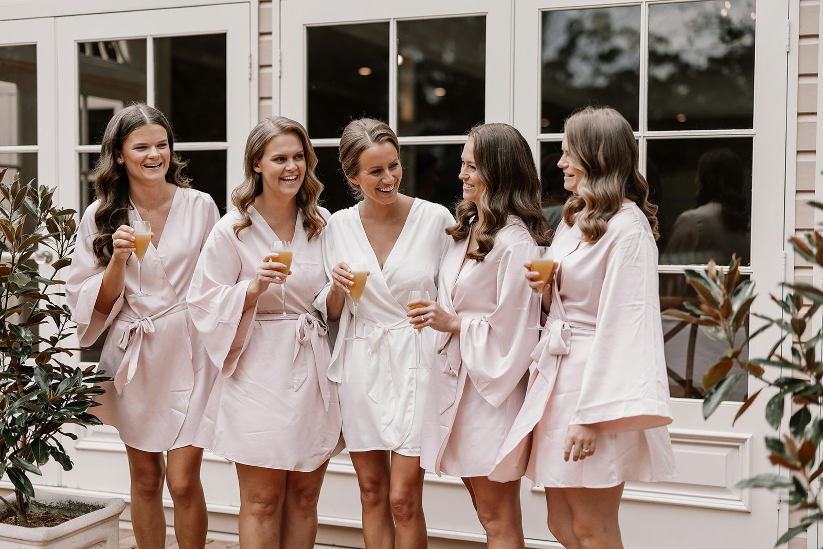 Bride and bridesmaids drinking orange juice