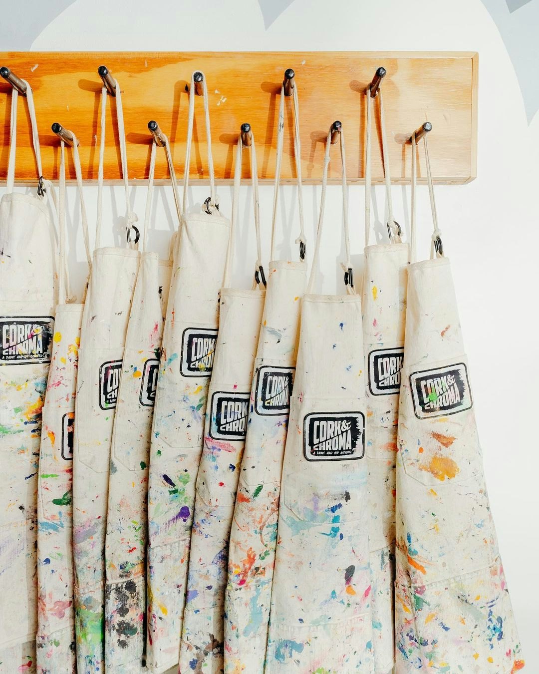Paint aprons hanging up on a rack