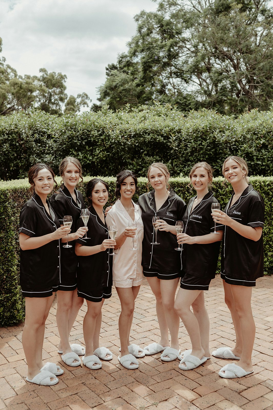Bride and bridesmaids sipping champagne