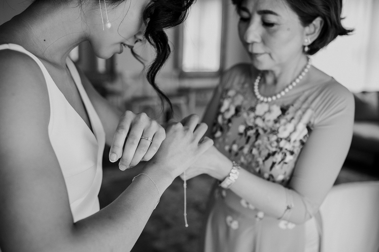 Brides mother putting on bracelet