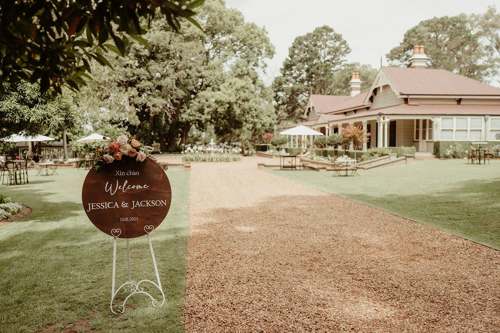 Wedding welcome sign with homestead in background