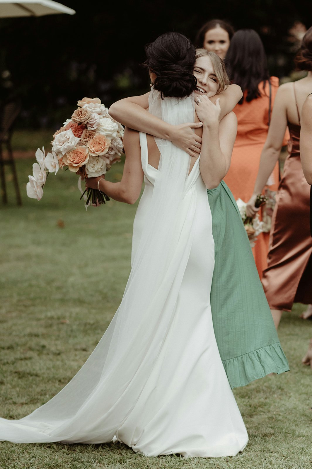 Bride and friend hugging