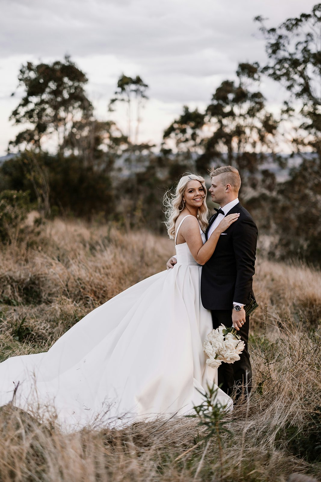 Bride and groom in fields