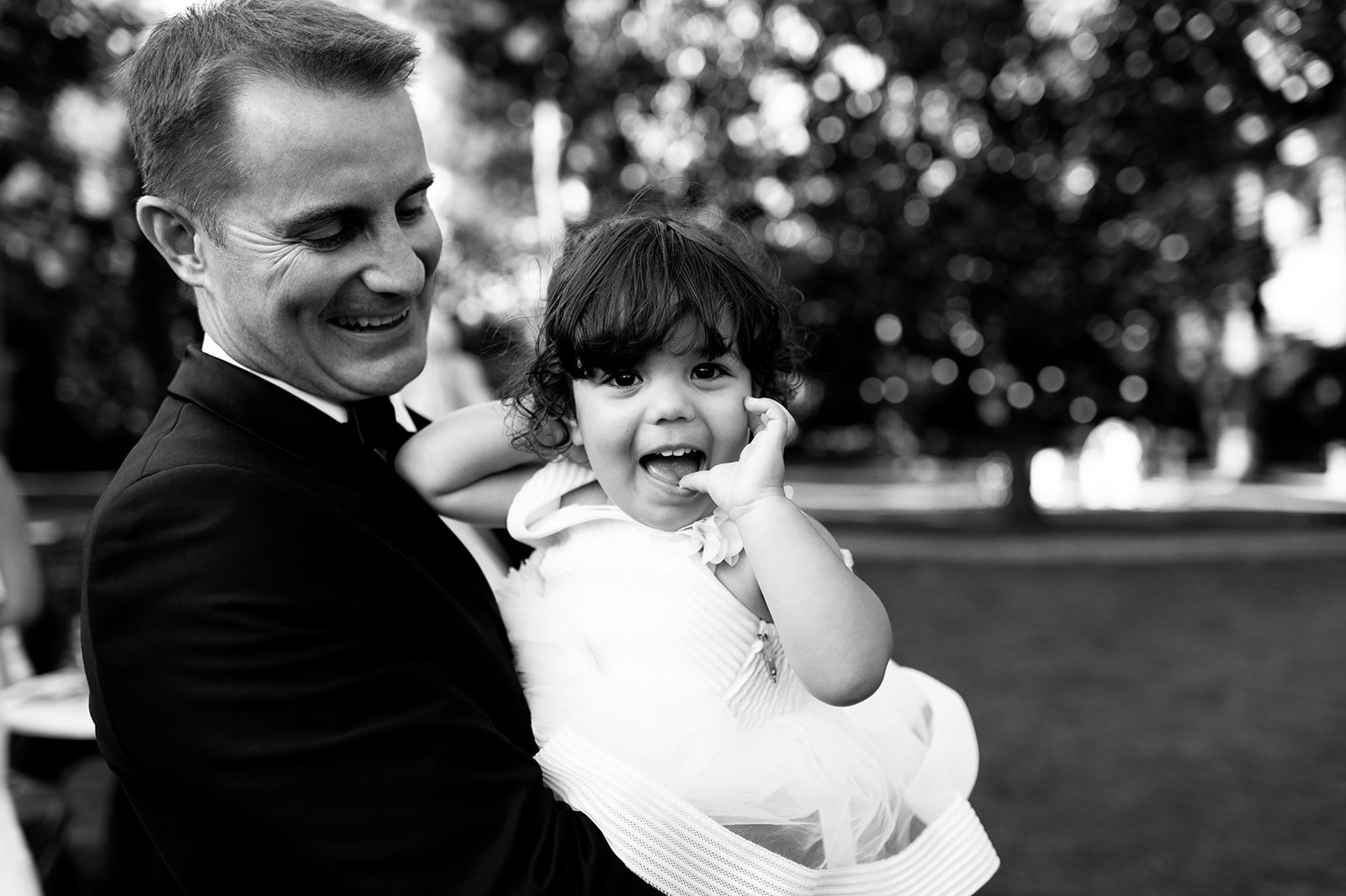 Groom and daughter laughing