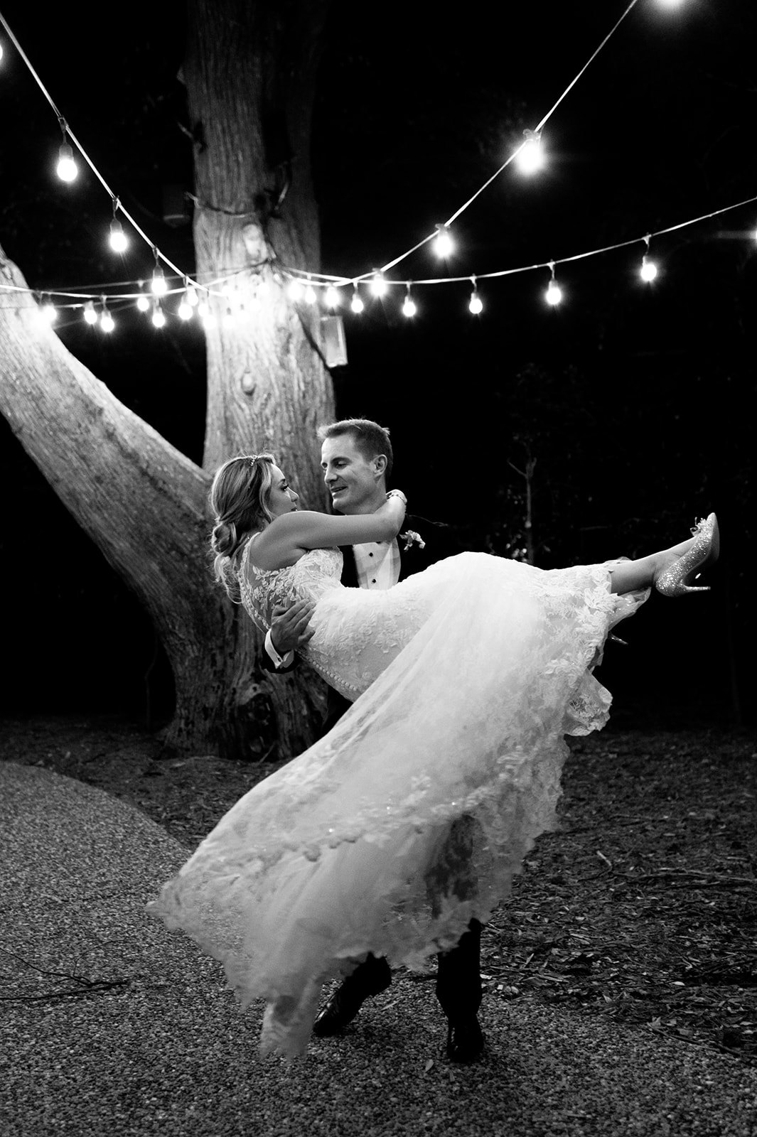 Bride and groom dancing at night