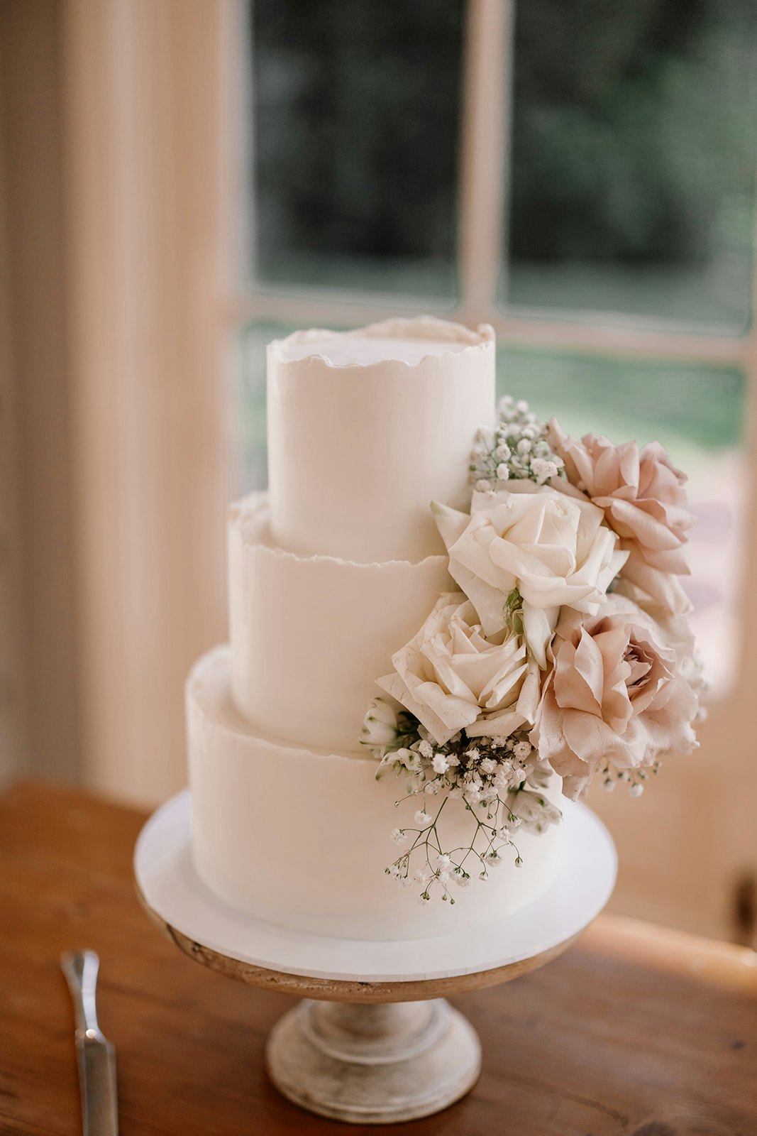 Wedding cake with flowers on the side