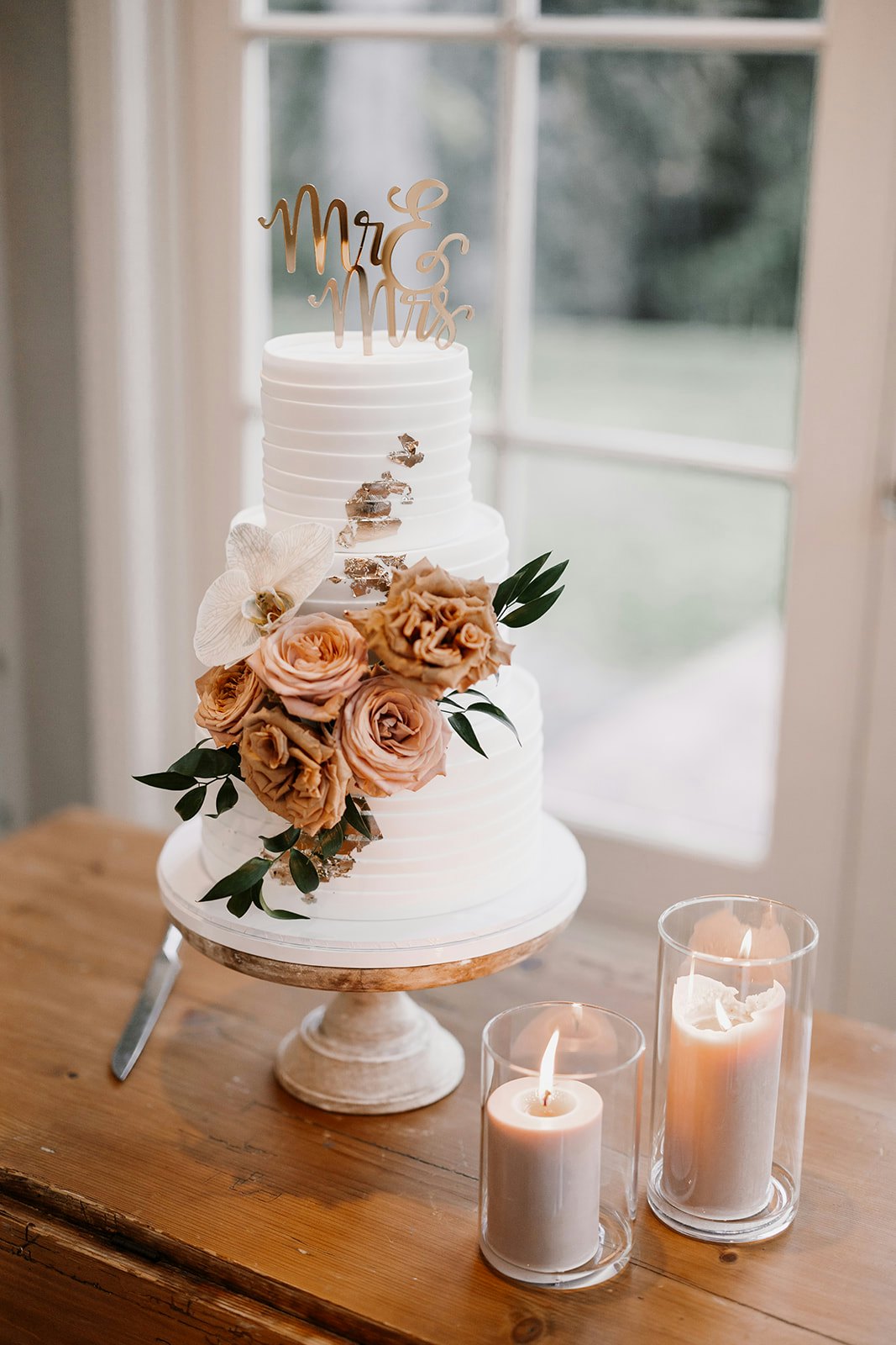 Wedding cake with candles beside