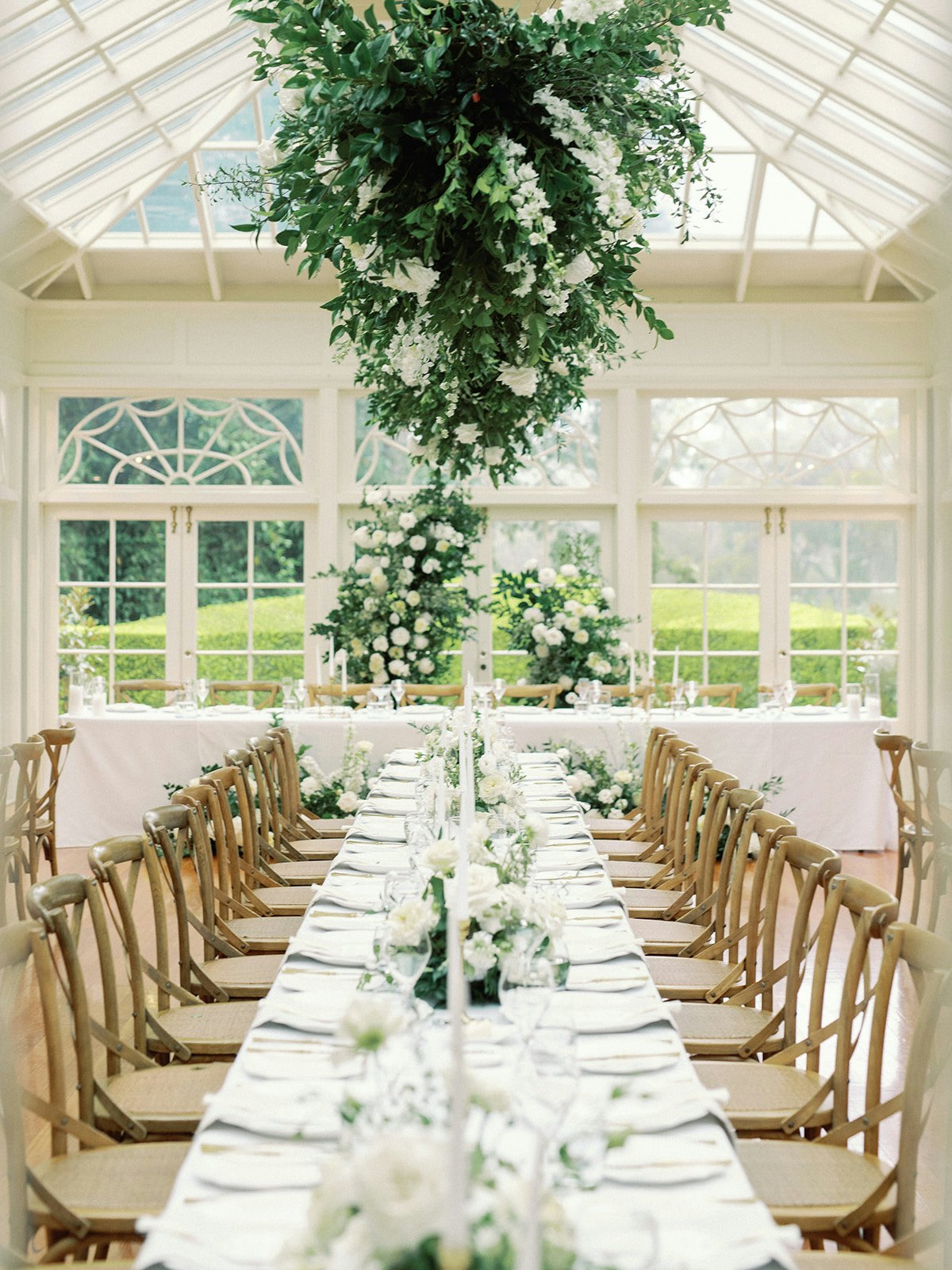 Indoor wedding reception with floral hanging display