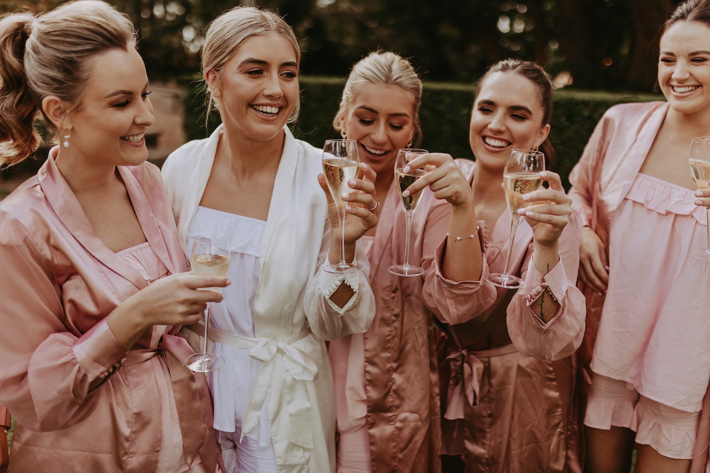 Bride and bridesmaid drinking champagne