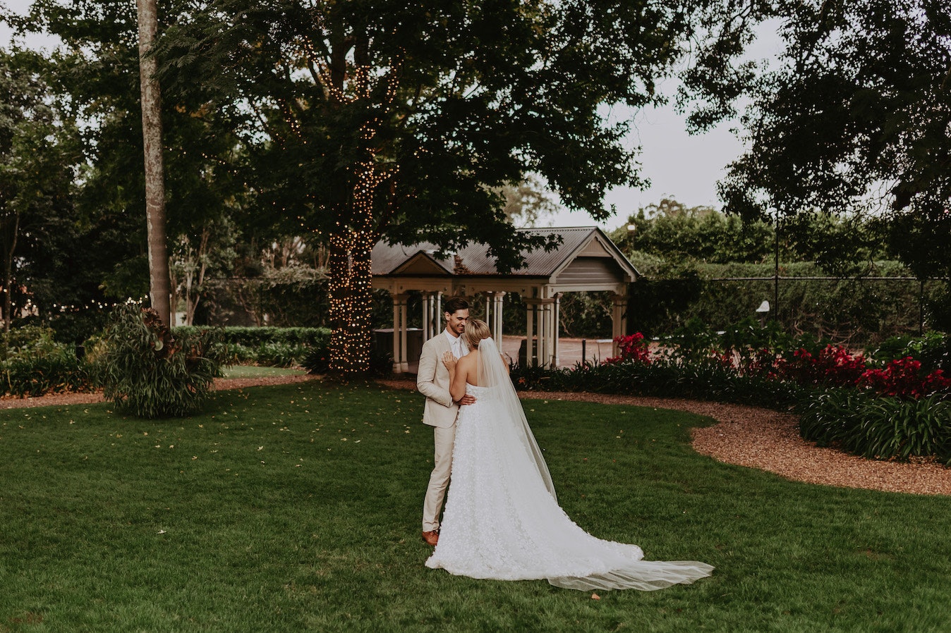 Bride and groom standing on lawn