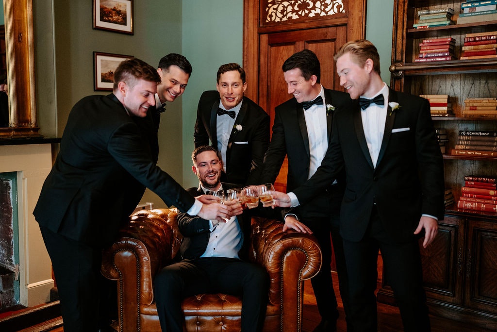 Groom and groomsmen drinking whisky