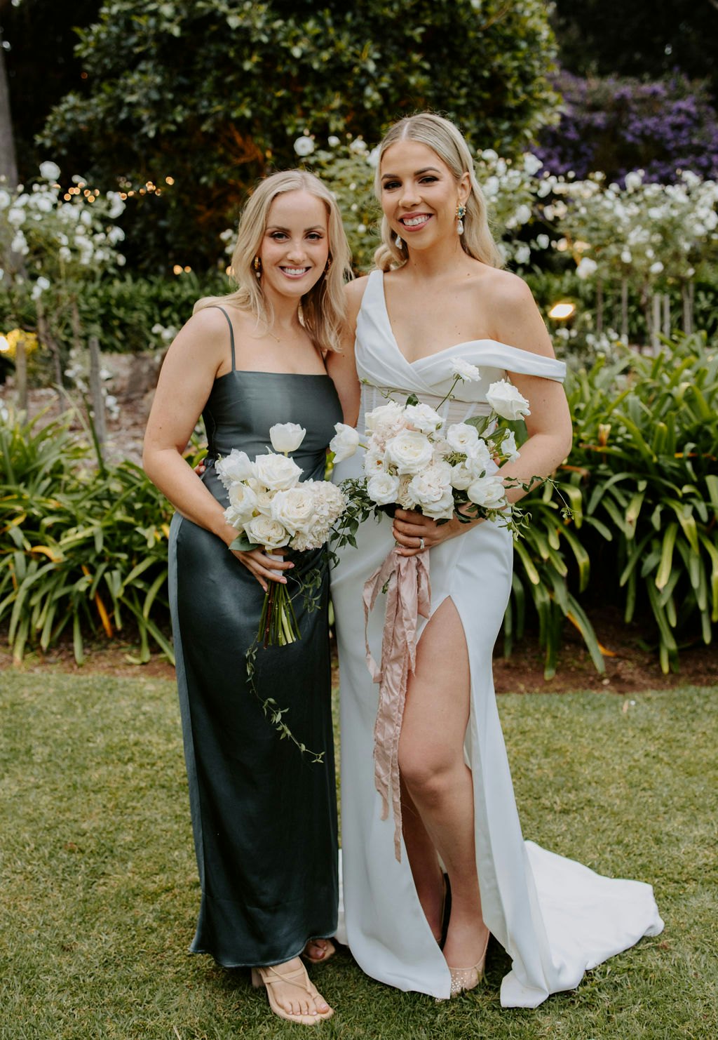 Bride and bridesmaid holding flowers