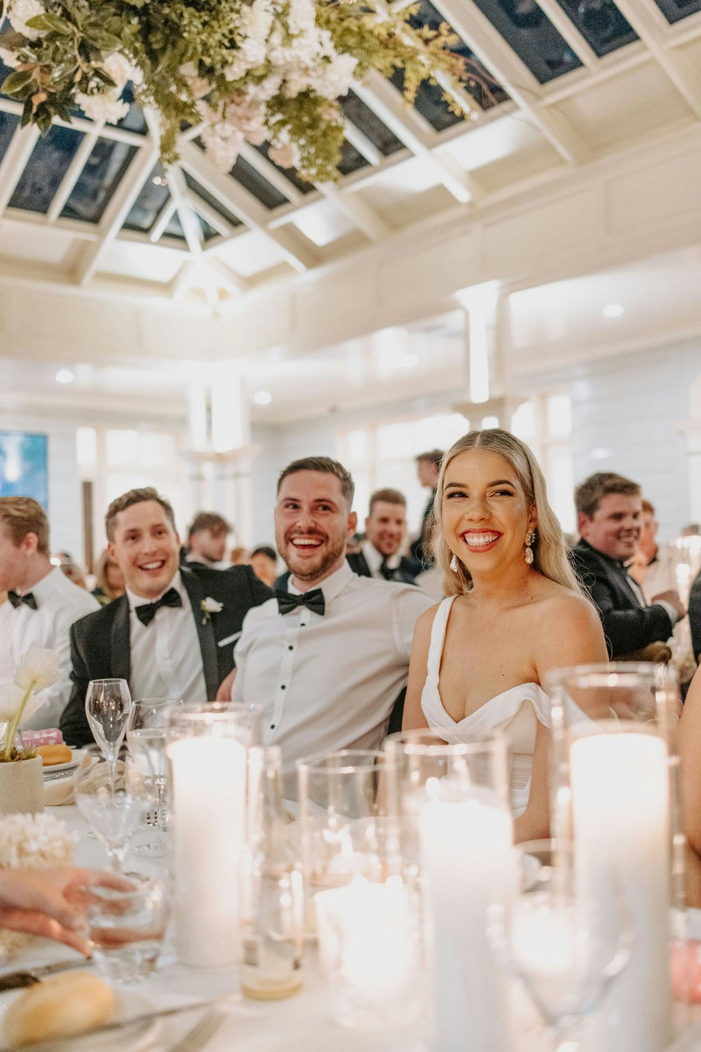 Bride and groom sitting at table laughing