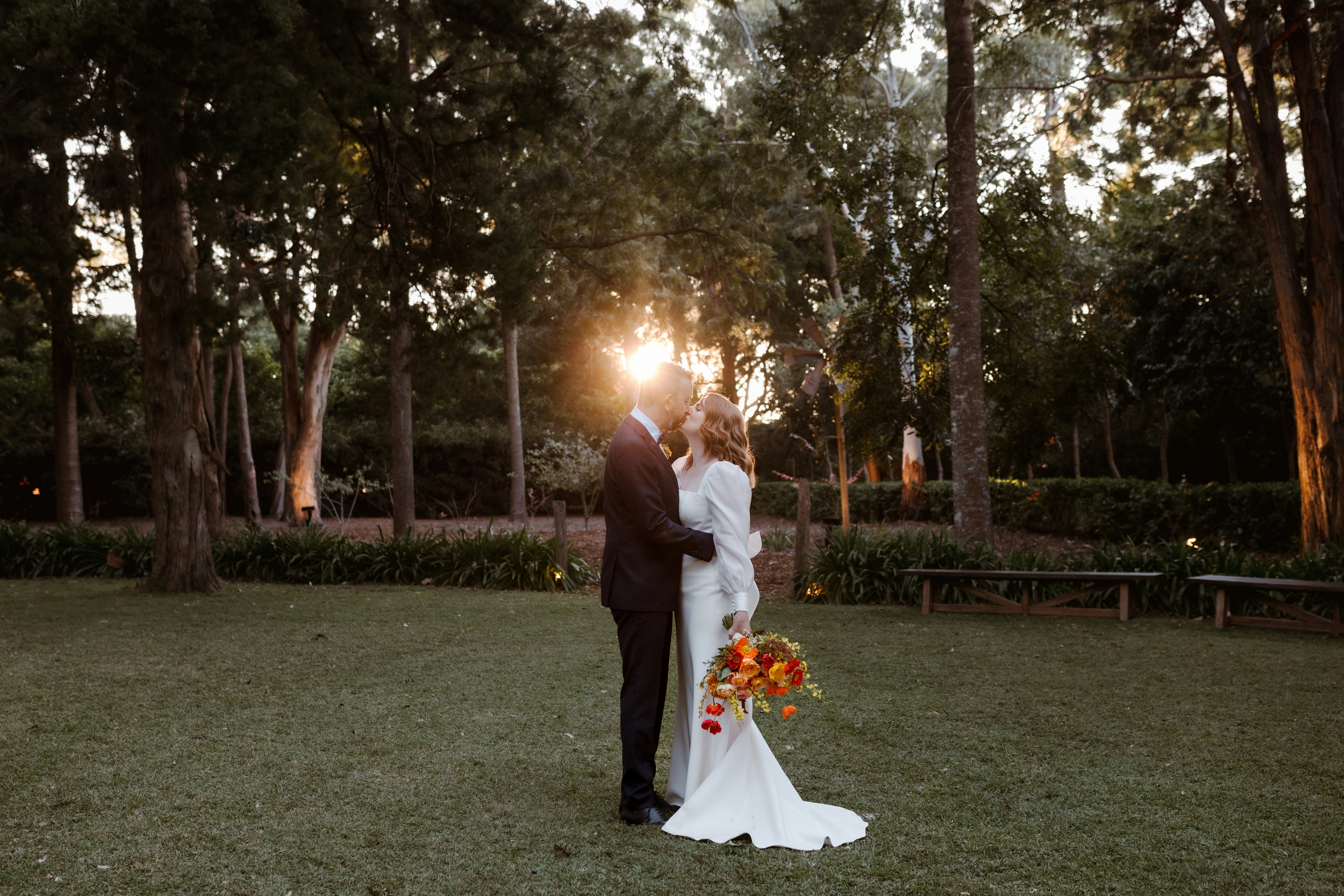 Bride & groom embracing at sunset