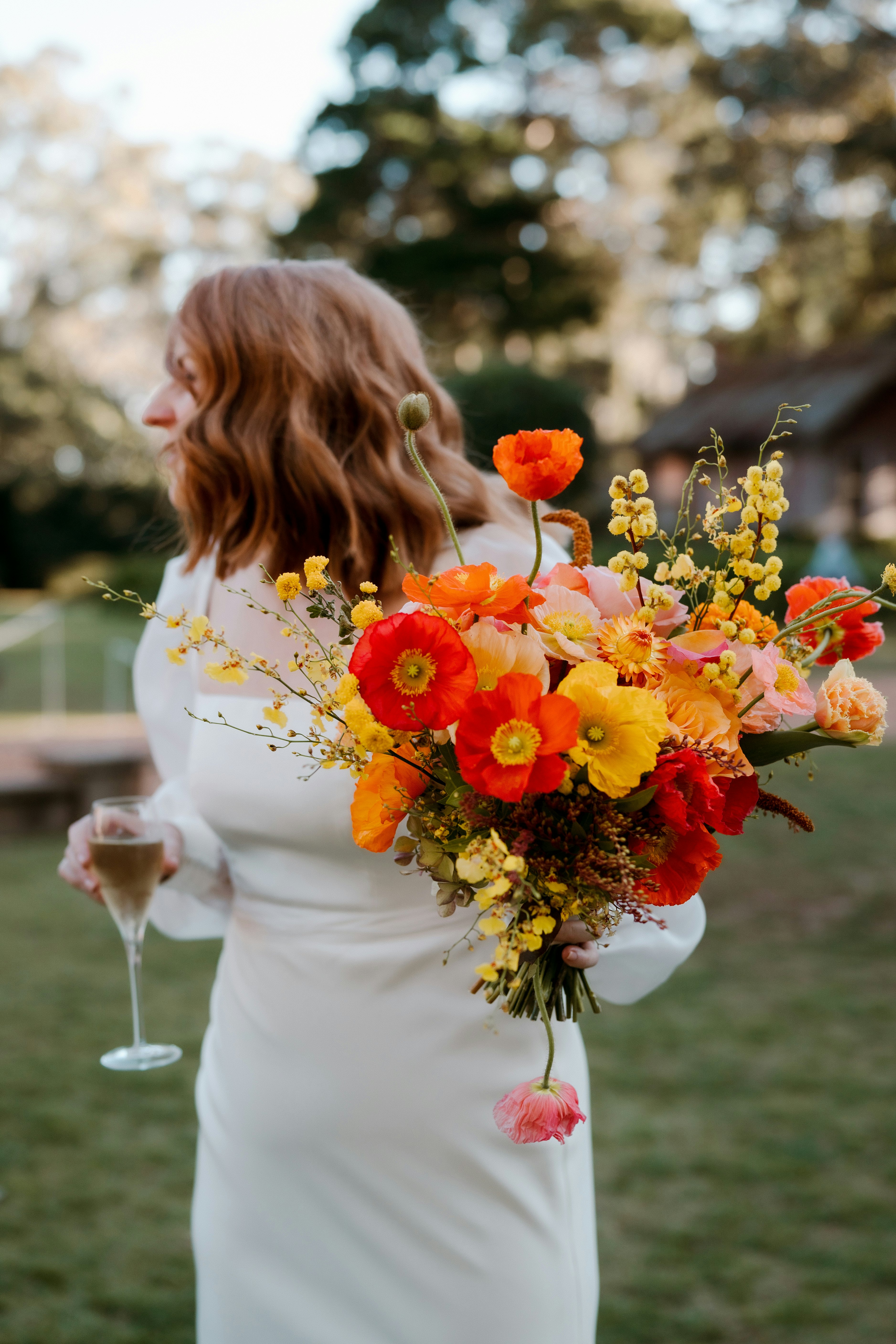 Bride holding bouquet & champagne