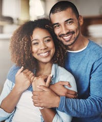 smiling couple hugging each other in a kitchen