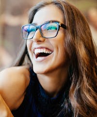 Woman wearing glasses laughing