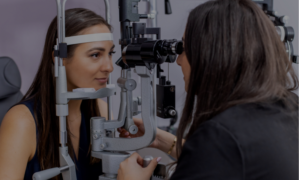 Female patient having her eyes examined through a device