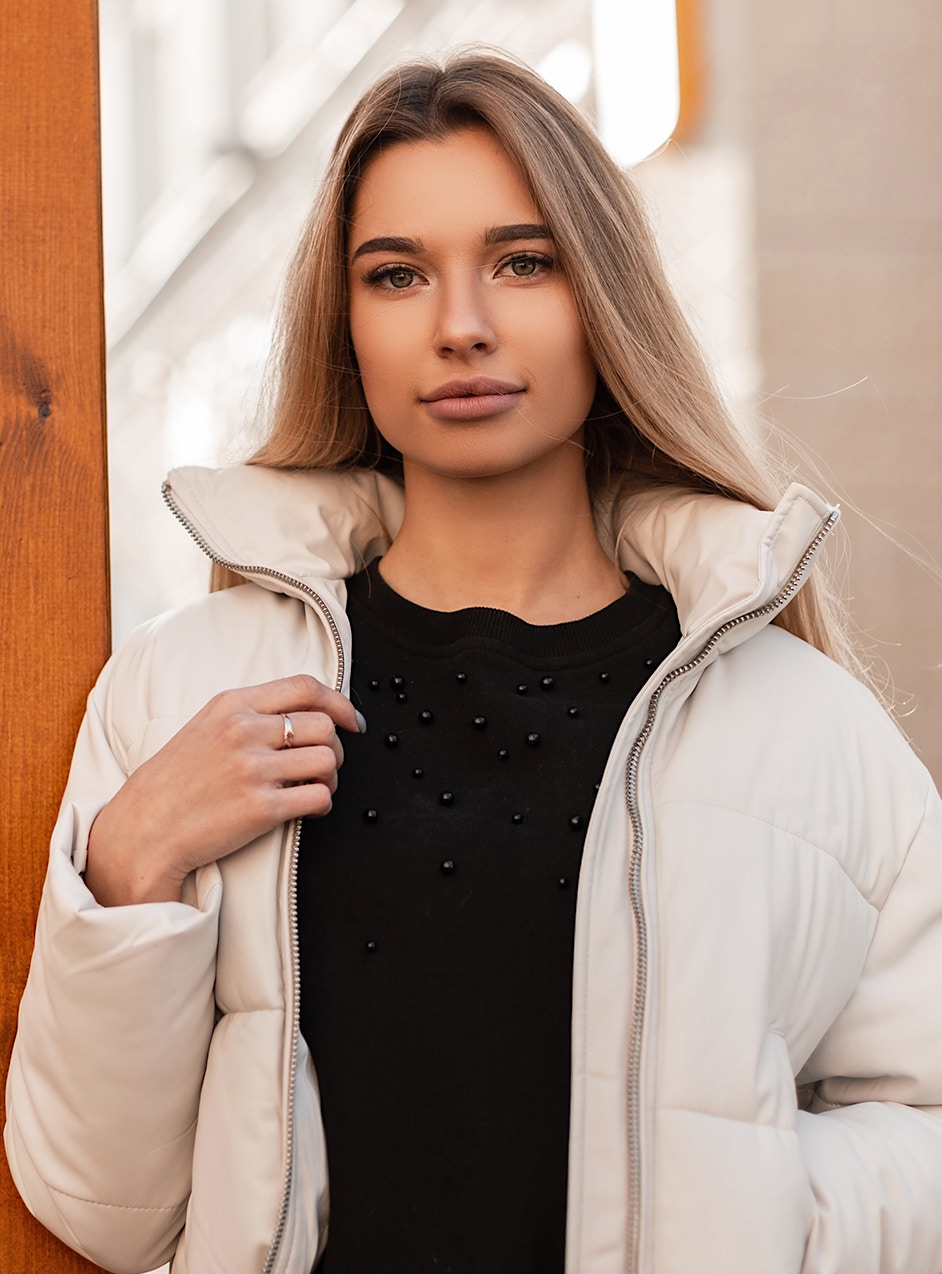 woman with beautiful skin holding her coat after a chemical peel in Frederick, MD