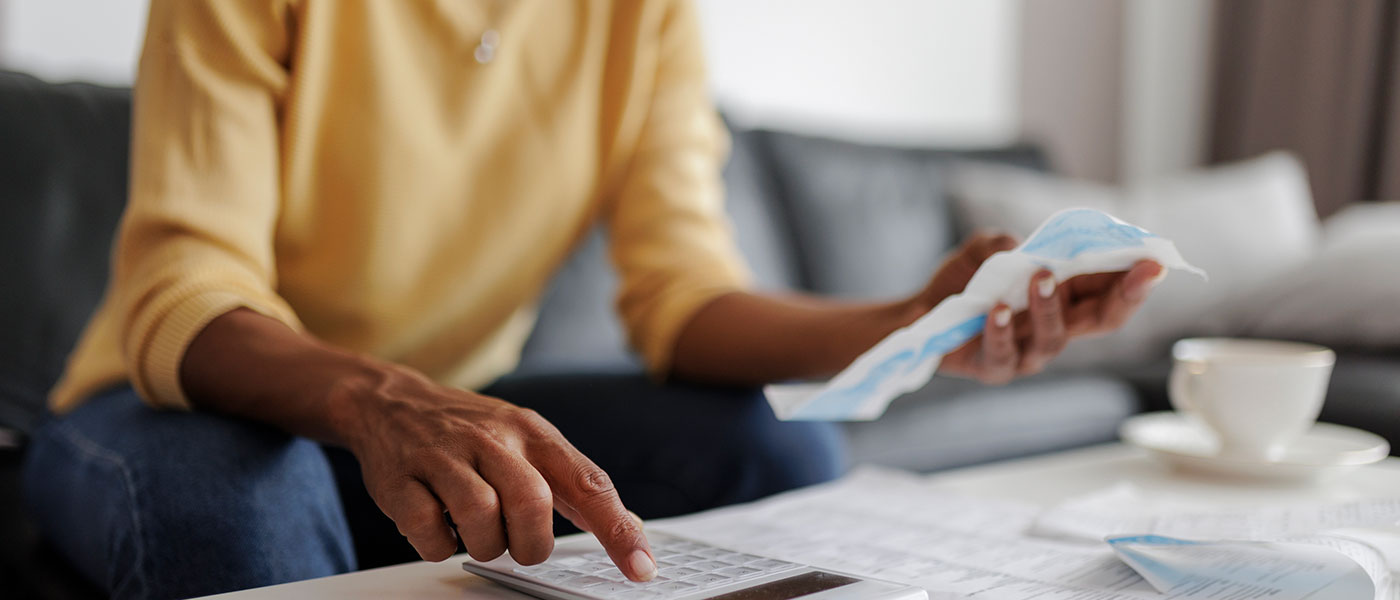 Woman checking receipts for coverage on medical weight loss from Genesis Lifestyle Medicine.