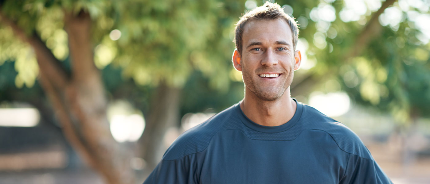 Happy man outside after GAINSWave therapy from Genesis Lifestyle Medicine.