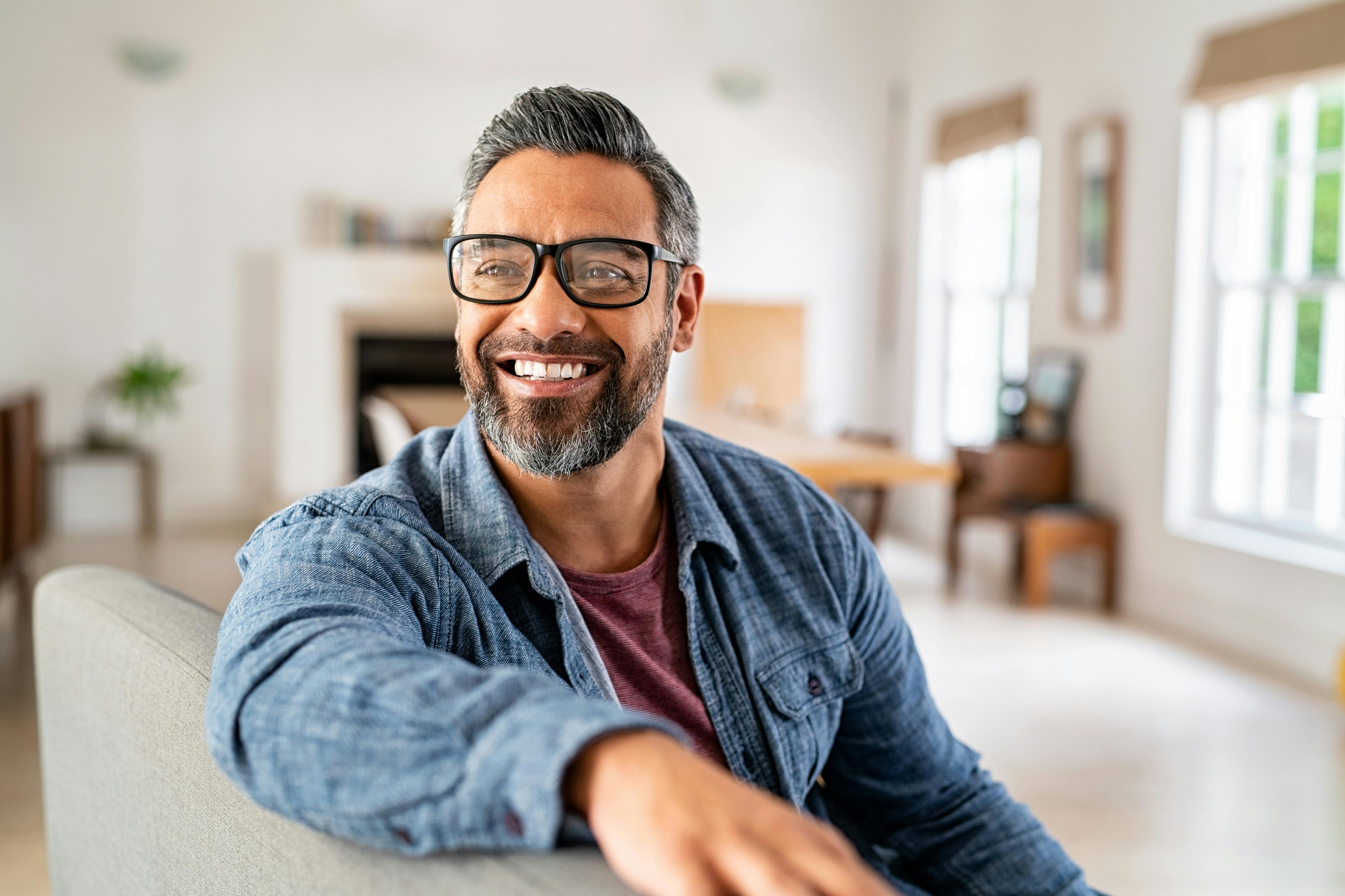 Confident man smiling, feeling empowered after ED treatment at Genesis Lifestyle Medicine.