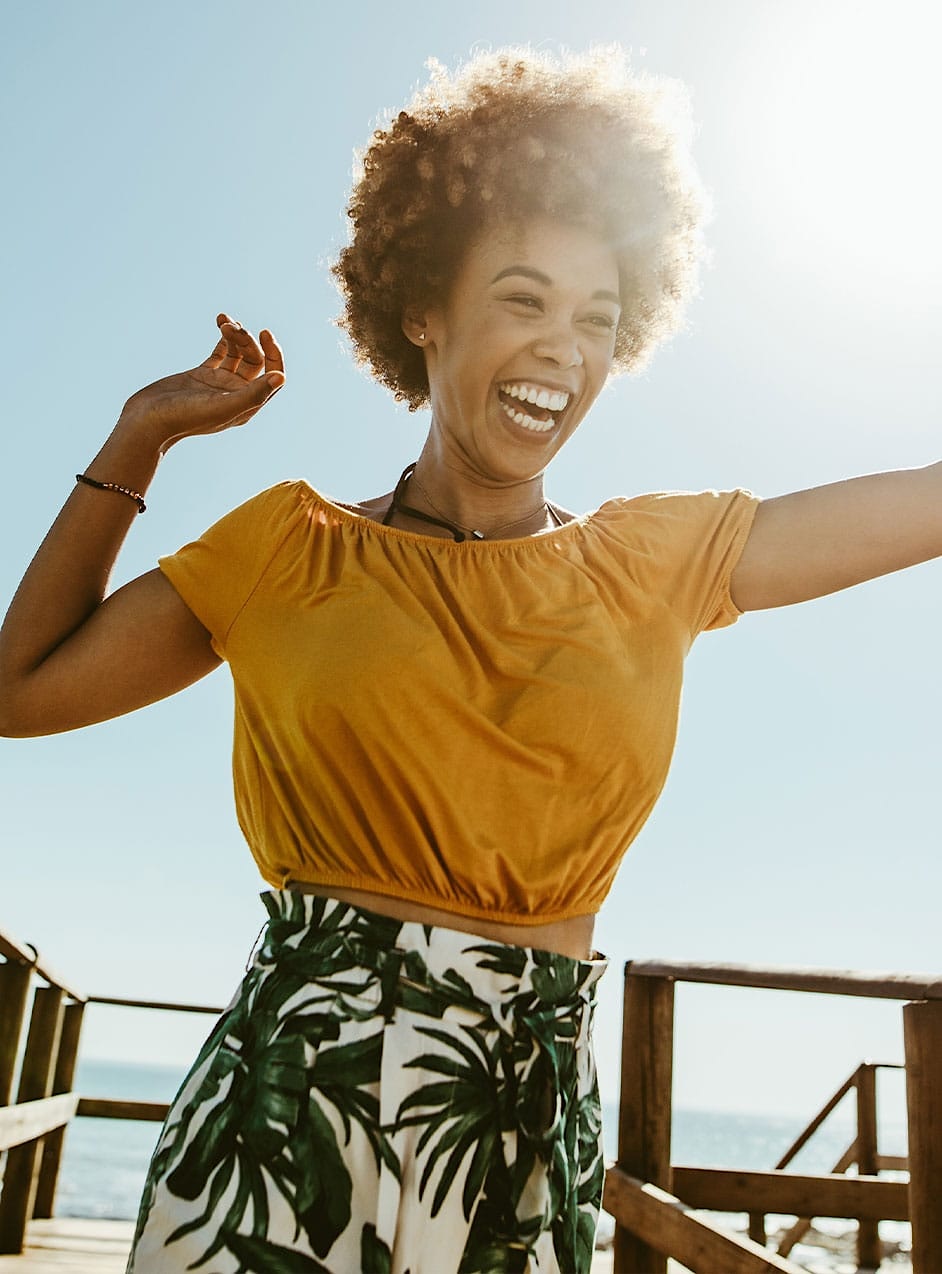 woman jumping and laughing after chemical peel in Omaha, NE