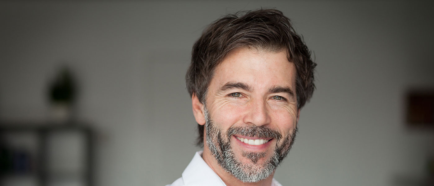Smiling man after the P-Shot from Genesis Lifestyle Medicine.