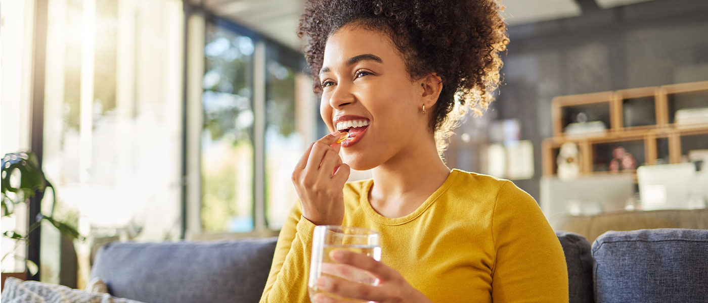 Woman taking GLP-1 medication from Genesis Lifestyle Medicine.