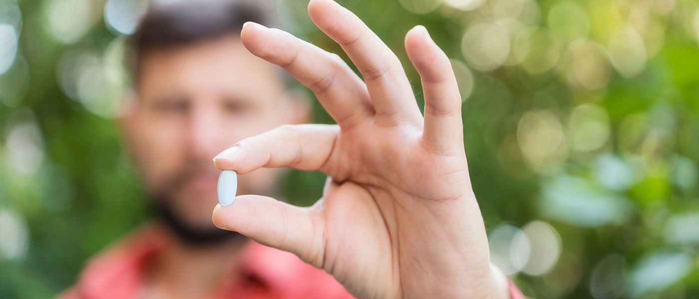 Man holding GLP-1 medication from Genesis Lifestyle Medicine.