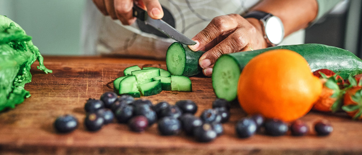 Man making a healthy meal after taking GLP-1 medication from Genesis Lifestyle Medicine.