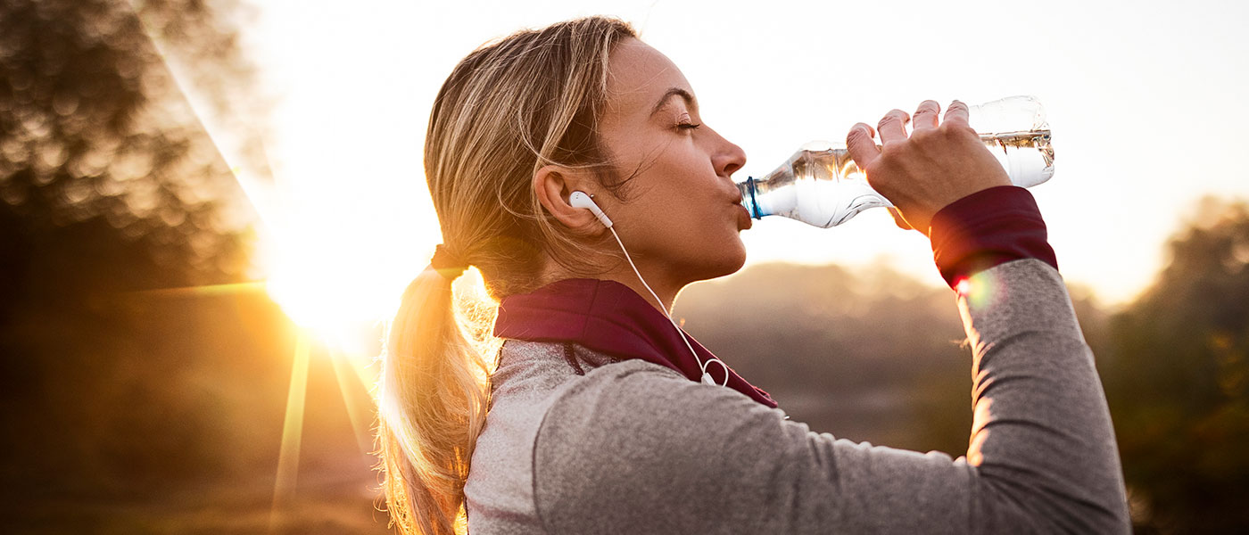 woman drinking water after medical weight loss program from Genesis Lifestyle Medicine