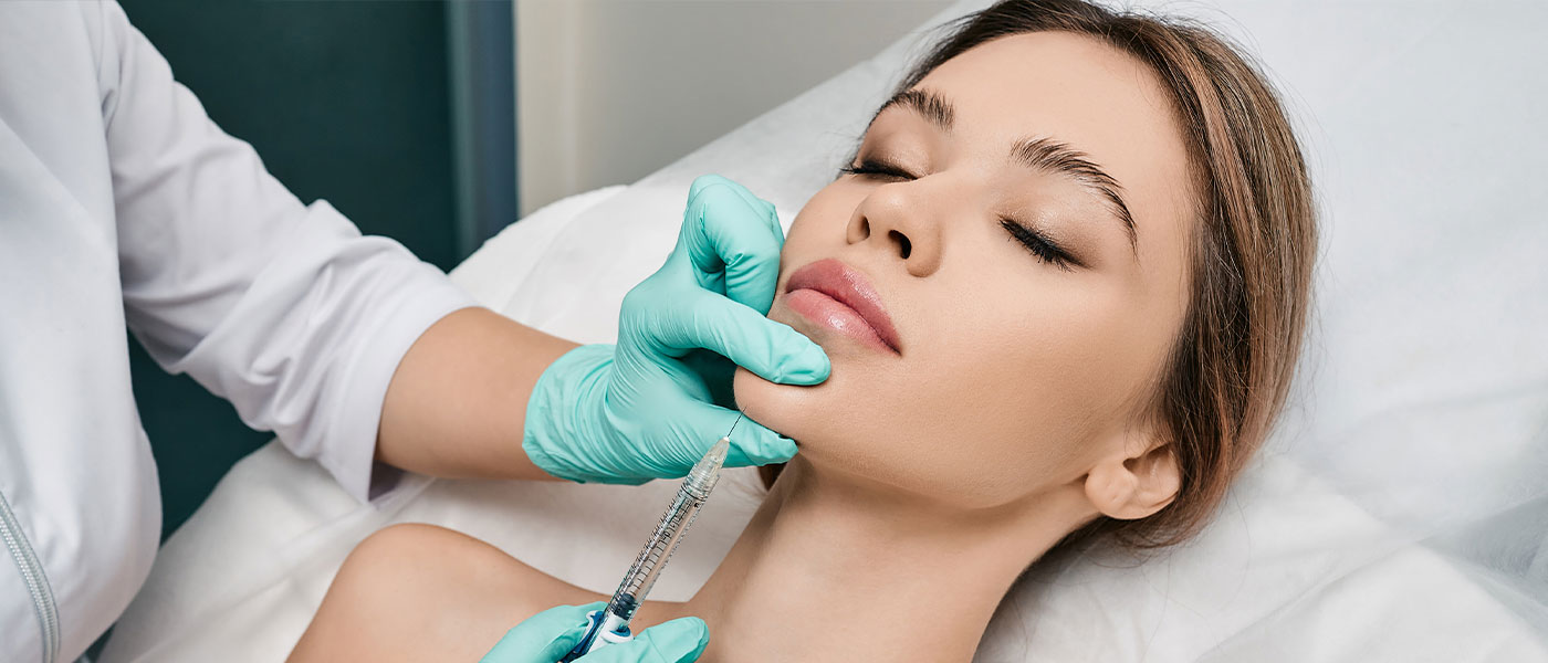 Woman receiving Kybella injection at Genesis Lifestyle Medicine.