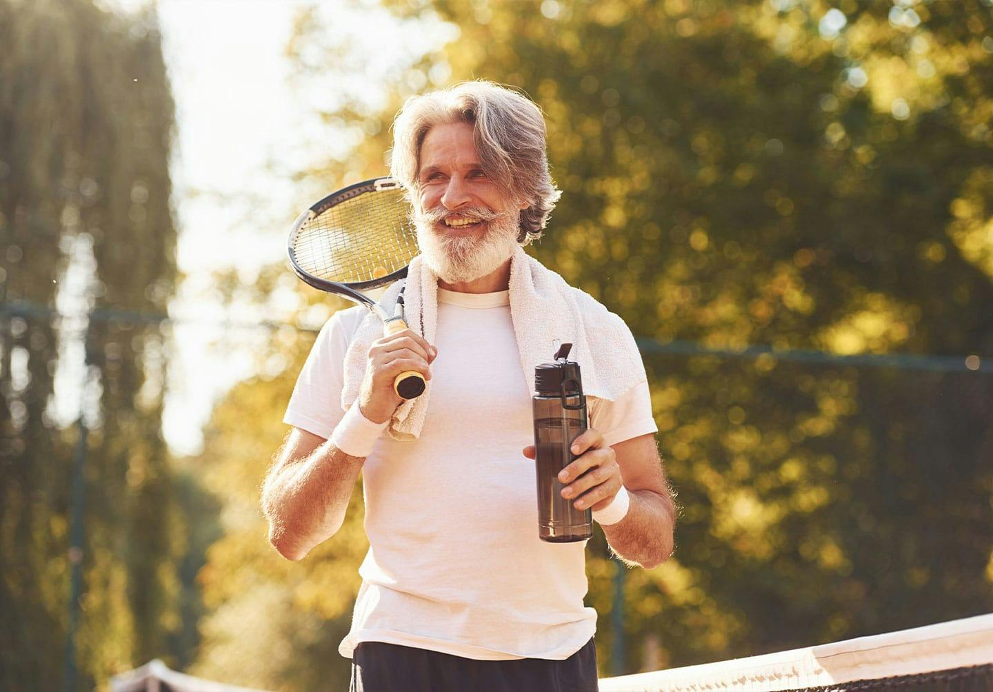 man playing tennis after medical weight loss in Dunn, NC
