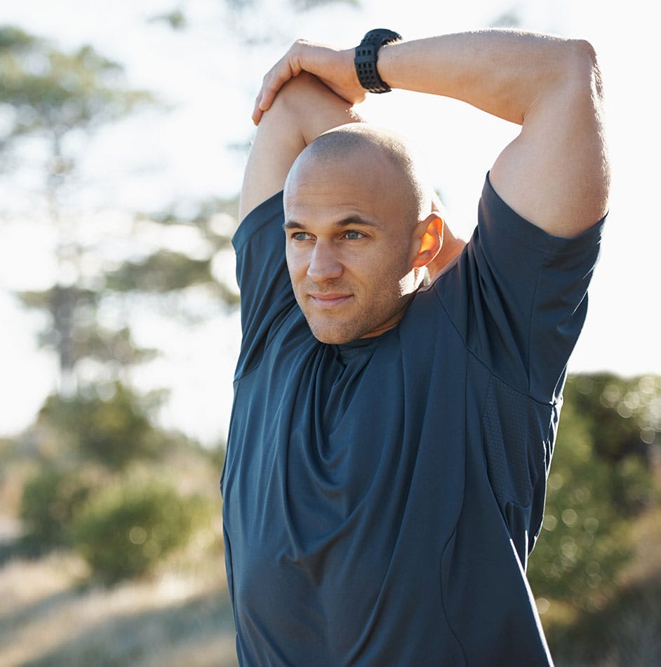 man stretching after hormone therapy in Cumming