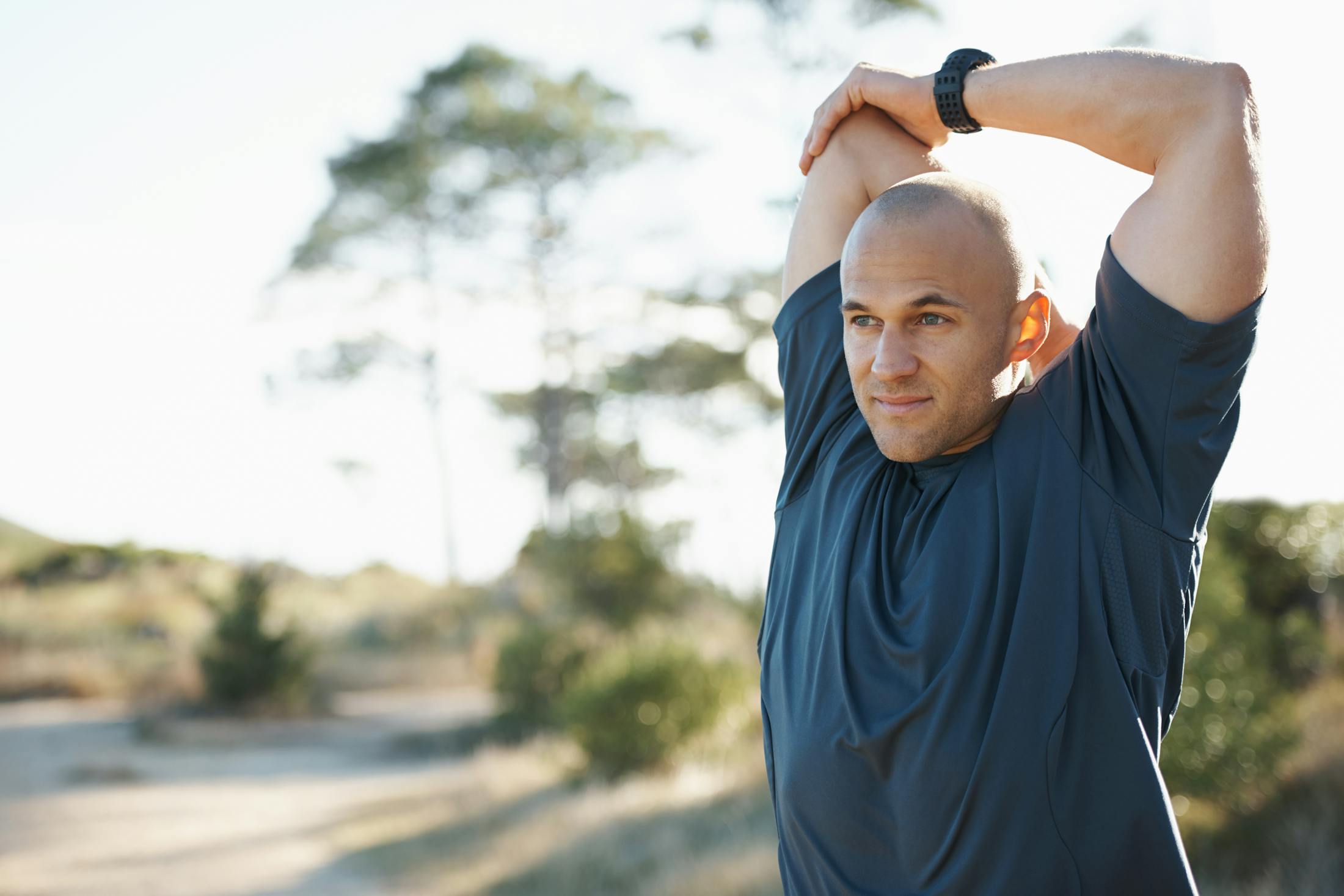 Man stretching before a workout after Tirzepatide treatment at Genesis Lifestyle Medicine.