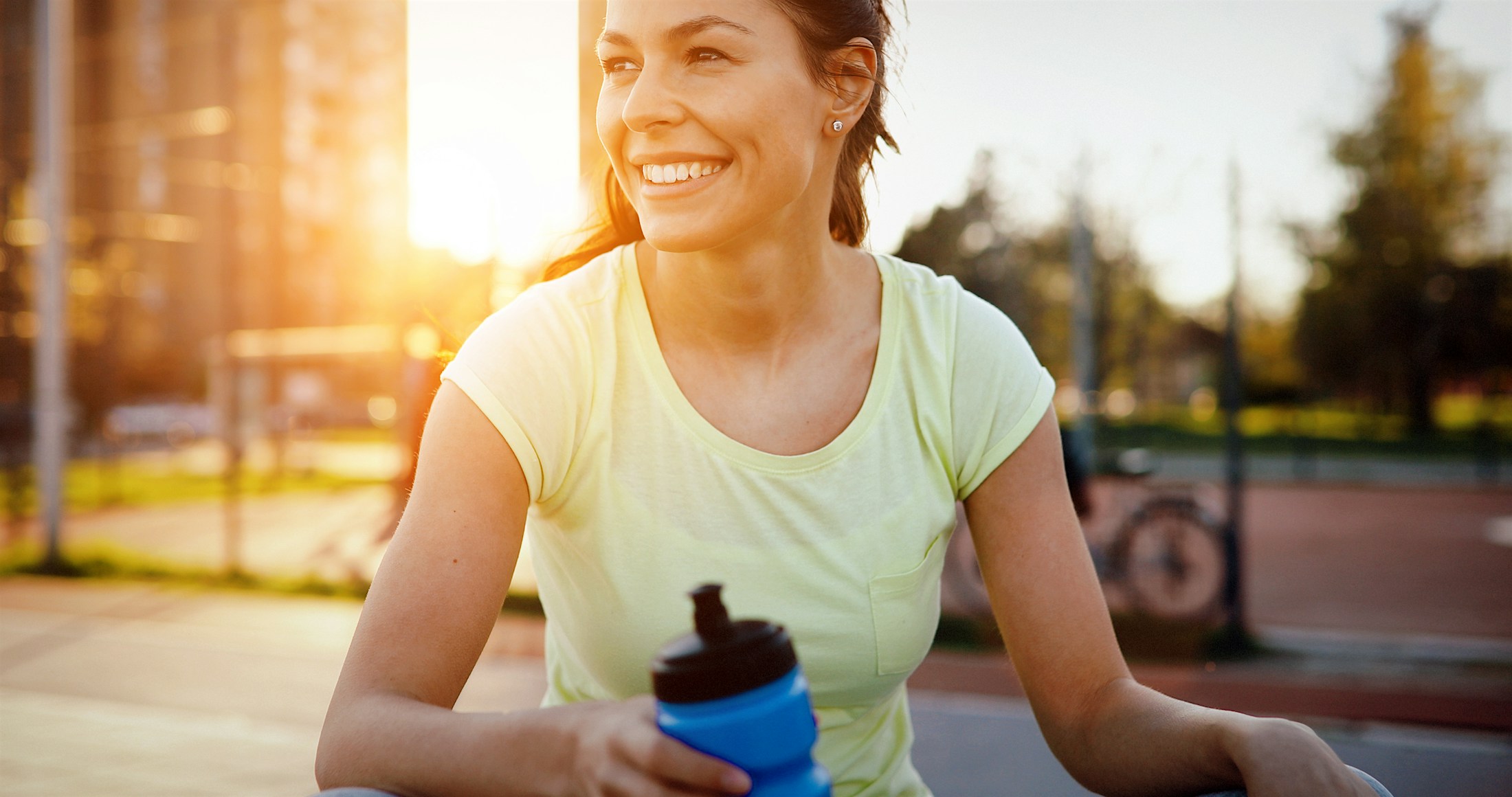 a woman smiling outside after getting weight loss medications in Long Beach.